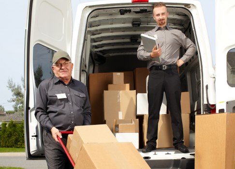 Professional movers handling furniture in a Belvedere residential street