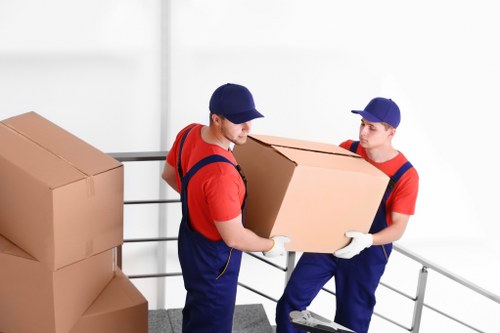 Packed boxes and moving team preparing for local removals