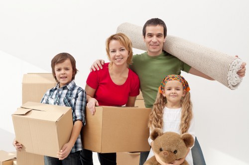 Movers carrying furniture carefully through a home doorway
