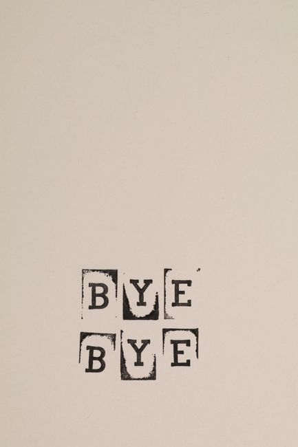 A white wall with a simple black stamp-style design featuring the word 'BYE' repeated twice in a grid pattern. The letters are arranged in four separate squares, each with a slightly distressed, stencil-like appearance. The indoor setting appears to be part of a home or office environment, with no additional objects or furniture visible in the immediate vicinity. This image may be used in the context of a home relocation or moving process, reflecting a farewell or ending phase, and is relevant to services offered by [COMPANY_NAME], such as removals and moving logistics.